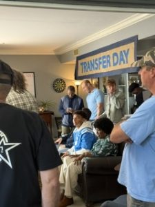 Family and friends gathered at a Transfer Day celebration for a student athlete
